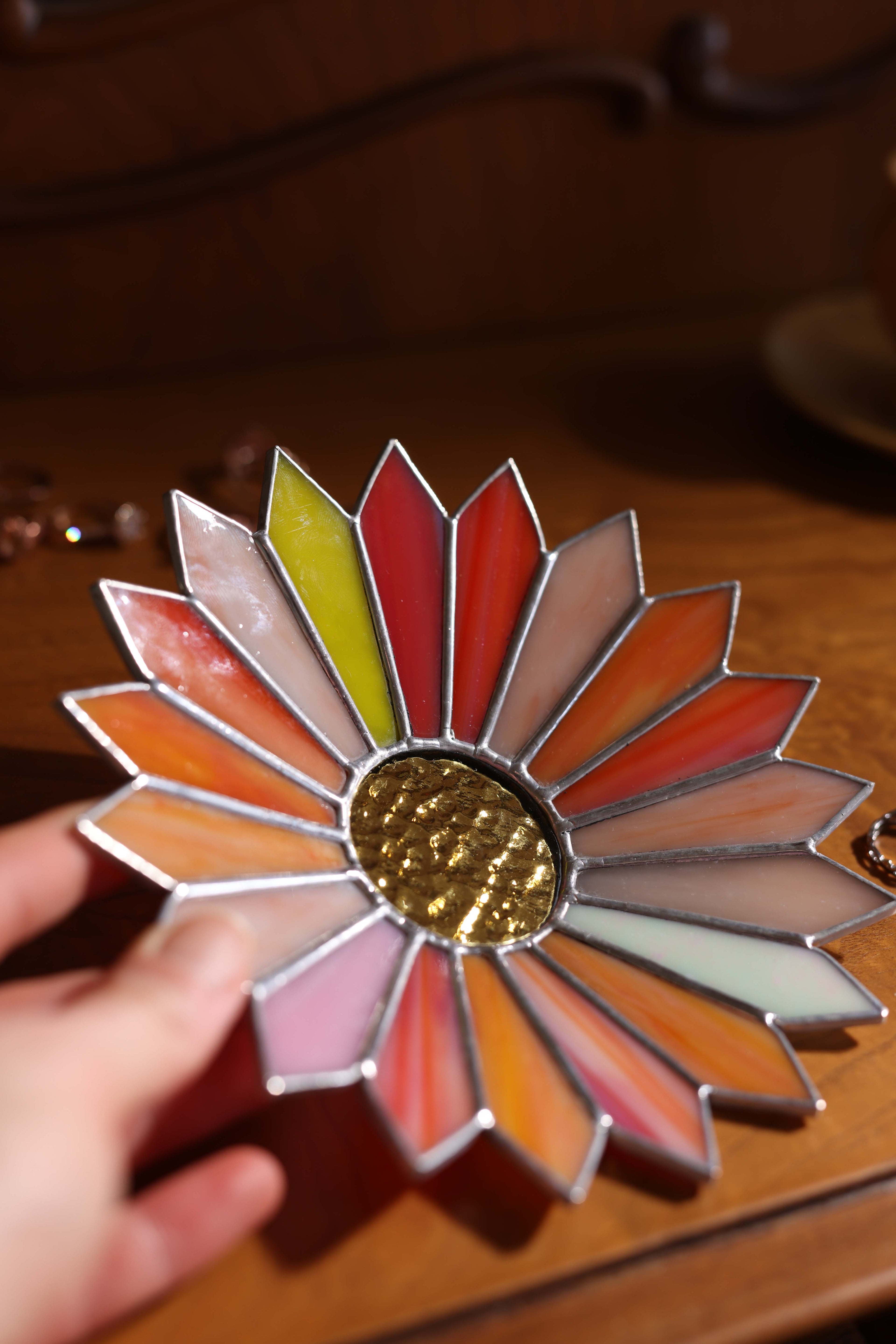 close up view of a handmade stained glass jewelry tray on wooden vanity dresser with mirror and rings, vintage home decor jewelry holder
