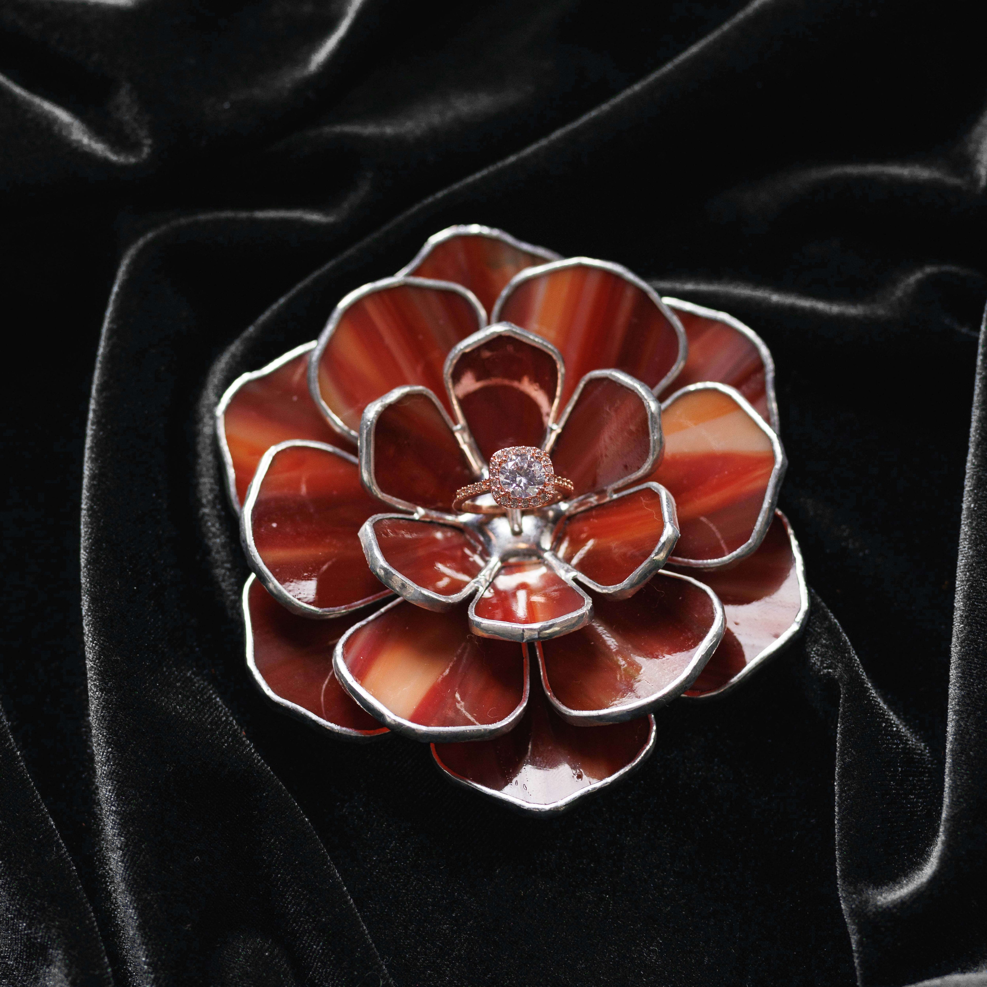 Stained glass ring dish with red and silver design on a black velvet background. Perfect gift for weddings, engagements or anniversary.