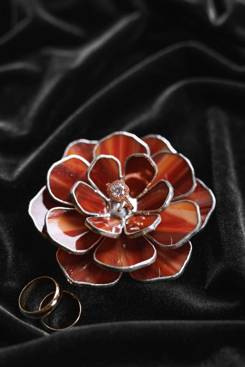 Ruby red stained glass peony ring dish with engagement ring on black velvet