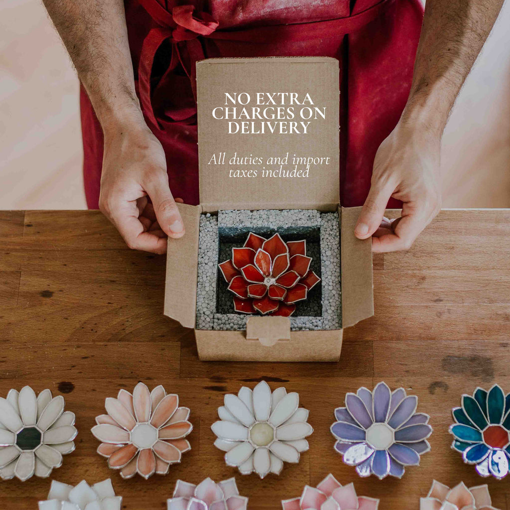Hand opening a package containing a handmade stained glass flower ring dish, with text indicating no extra charges on delivery and all duties and import taxes included; secure packaging presentation for international orders, highlighting safe shipping, ready-to-gift jewelry holder, and worry-free purchase experience.