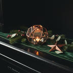 Geometric candle holder on blackened wood mantel