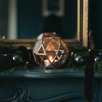 Geometric candle holder on midnight teal mantel
