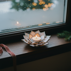 Pink candle holder by a vintage winter window