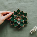 Handcrafted stained glass succulent ring dish in deep emerald green with copper trim, featuring a central ring holder for engagement or wedding rings; decorative jewelry holder for flat lay styling and meaningful couple gift.