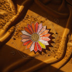 Sunburst shaped stained glass jewelry tray on a brown velvet surface