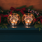 Tall geometric candle holder pair on teal mantel